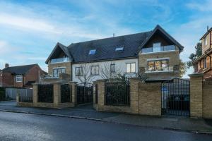 a large brick house with a black roof at The Isleworth Garden Retreat 3BR 2BA with Gated Parking in Isleworth