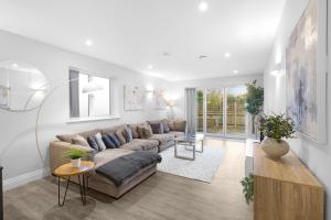 a living room with a couch and a table at The Isleworth Garden Retreat 3BR 2BA with Gated Parking in Isleworth