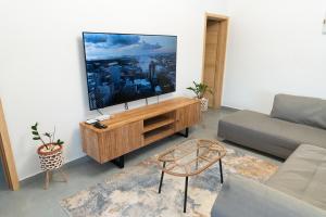 a living room with a flat screen tv on a wall at Arama Villa by Swarga Mauritius in Cap Malheureux