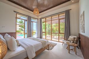 a bedroom with a large bed and a large window at Diamond Hill Villa in Labuan Bajo +70 photos