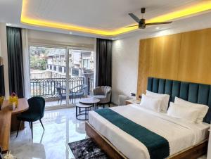 a hotel room with a bed and a balcony at Amritara Chakra River Resort - Closest Luxury Resort to Neelkanth Temple in Mohan Chatti +78 photos
