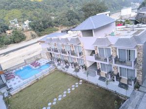 an aerial view of a house with a swimming pool at Amritara Chakra River Resort - Closest Luxury Resort to Neelkanth Temple in Mohan Chatti