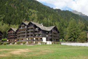 a large building in front of a mountain at Appartement Les Balcons du Savoy in Chamonix-Mont-Blanc