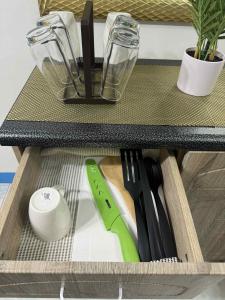 a drawer with knives and other kitchen utensils in it at Joy's Home Rental in Tagbilaran City