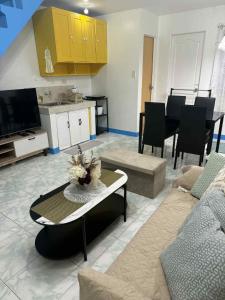 a living room with a couch and a table at Joy's Home Rental in Tagbilaran City