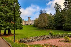 a building in the middle of a green park at Apex Dunblane Hydro in Dunblane