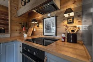 een keuken met houten wanden en een aanrecht met een wastafel bij Charming cabin in Hemsedal Golf Alpin - ideal for families, fishing & skiing in Granheim