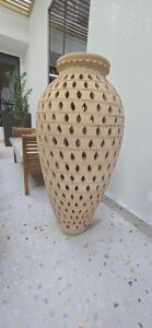 a large vase sitting on a floor in a room at Modern Omani Inspired Apartment in Muscat in Muscat