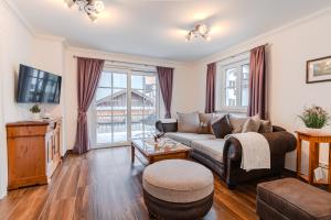 a living room with a couch and a table at Villa Eisl-Raudaschl in St. Wolfgang