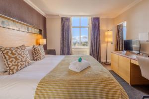 a hotel room with a bed with a towel on it at Apex Dunblane Hydro in Dunblane +59 photos