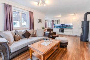 a living room with a couch and a table at Villa Eisl-Raudaschl in St. Wolfgang