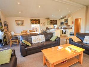 a living room with a couch and a table at Kingfisher Lodge - Arnside 14 in Carnforth