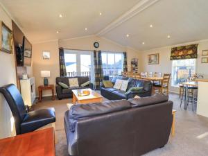 a living room with a couch and chairs and a table at Kingfisher Lodge - Arnside 14 in Carnforth