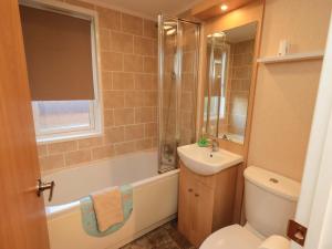 a bathroom with a sink and a toilet and a shower at Kingfisher Lodge - Arnside 14 in Carnforth +20 photos
