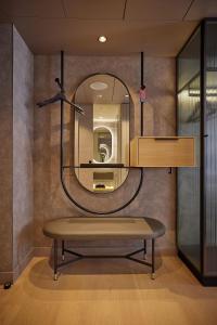 a dressing room with a bench and a mirror at ATLANTIC Hotel Frankfurt in Frankfurt +16 photos