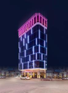 a building with purple and blue lights on it at Thai Ha Hotel in Ha Long