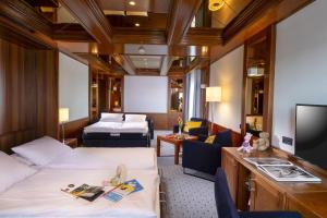 a hotel room with two beds and a flat screen tv at Maritim Hotel Darmstadt in Darmstadt +61 photos