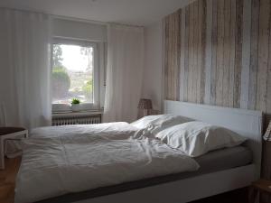 Fewo Am Wald في Balve: سرير أبيض في غرفة نوم مع نافذة