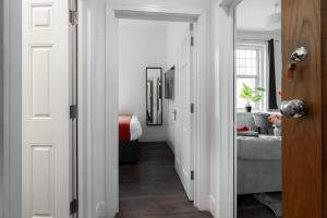 a hallway leading to a bedroom with a bed at The Regency | Seafront Lux Apartments! in Southend-on-Sea