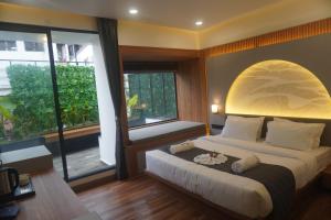 a bedroom with a bed and a large window at The Lovedale Kodaikanal Stay & Hotel in Kodaikānāl +91 photos