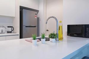 a kitchen with a counter with potted plants on it at Studio Diane in Permatang Pauh