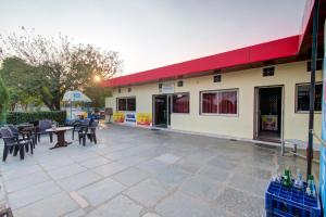 a building with a patio with tables and chairs at Hotel O Vishal in Jaipur +29 photos