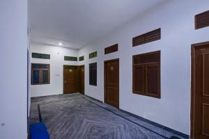 a room with white walls and wooden doors at Hotel O Vishal in Jaipur