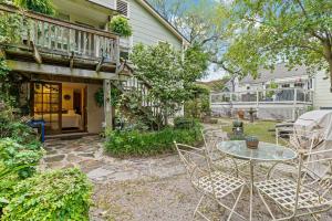 a patio with a table and chairs in front of a house at La Petite Fleur-Charming Park Circle Private Studio in Charleston