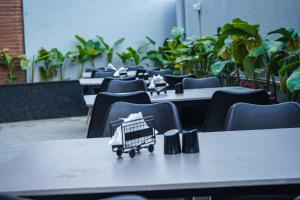 a row of tables and chairs with a shopping cart on them at The Lovedale Kodaikanal Stay & Hotel in Kodaikānāl