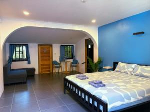 a bedroom with a bed and a blue wall at Think Koh Tao in Koh Tao