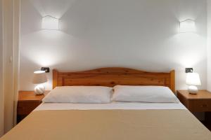 a bedroom with a bed with two lamps on both sides at RESIDENCE CERRA in Otranto