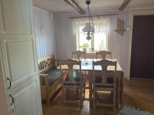 a dining room with a table and chairs and a window at Dog-friendly cottage with boat & private jetty at Tjörn SE09170 in Krommeröd