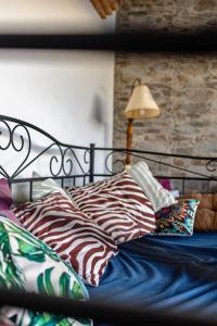 un letto con una struttura nera e cuscini e una lampada di Vivienda rural La Monería a Las Delgadas Altre 68 foto