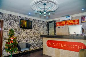 a hotel lobby with a christmas tree in the corner at Triple Tee Hotel in Lagos