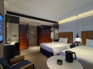 Voodi või voodid majutusasutuse FunGee Hotel Changsha Wuyi Square Metro Station Branch toas