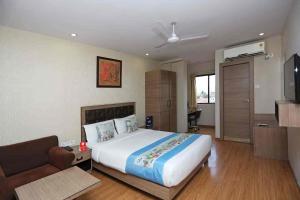 a bedroom with a large bed and a couch at Goswami property in Jaipur