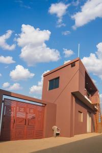 a building with a chair in front of it at Hari Har guest house in Chhatarpur