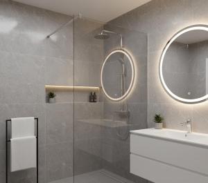 a bathroom with a shower and a sink and a mirror at Görgülü Apart 06 in Mamak