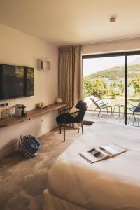 a hotel room with a bed and a large window at Villa Caroline, Lac d'Annecy in Duingt