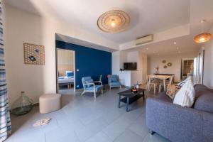 a living room with a couch and a table at Les appartements de l'Helios - Ile des Embiez in Six-Fours-les-Plages