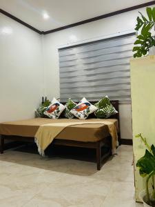 a bed with pillows on it in a room at Sinta Stay in El Nido