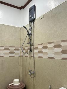 a shower in a bathroom with a toilet at Sinta Stay in El Nido