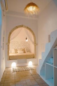 a bedroom with a bed in the middle of a room at Dar Ayline in Erriadh