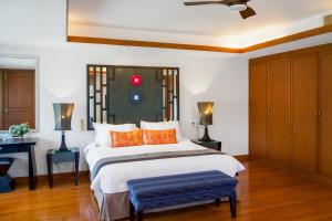 a bedroom with a large bed with orange pillows at Luxury Pool Villa Laguna Resort Near Layan Beach - 2 bedrooms 6 people in Layan Beach +62 photos