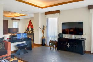 a living room with a tv and a dog in it at Luxury Pool Villa Laguna Resort Near Layan Beach - 2 bedrooms 6 people in Layan Beach