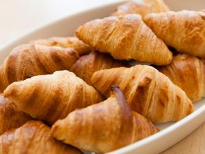 a white bowl filled with croissants on a table at Shirakabako Hotel Paipuno Kemuri in Chino