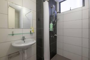 a bathroom with a shower and a sink at Studio Diane in Permatang Pauh