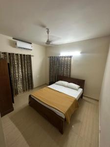 a bedroom with a large bed in a room at Ironwood Villa in Cochin