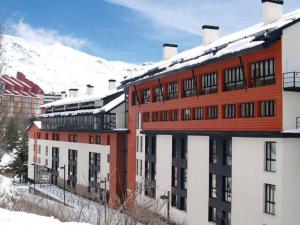 a large red building with snow on top of it at SNOW PARADISE GORBEA junto al Telecabina parking GRATIS in Sierra Nevada