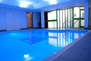 a swimming pool with a chair in a building at Best Western Ipswich Hotel in Ipswich